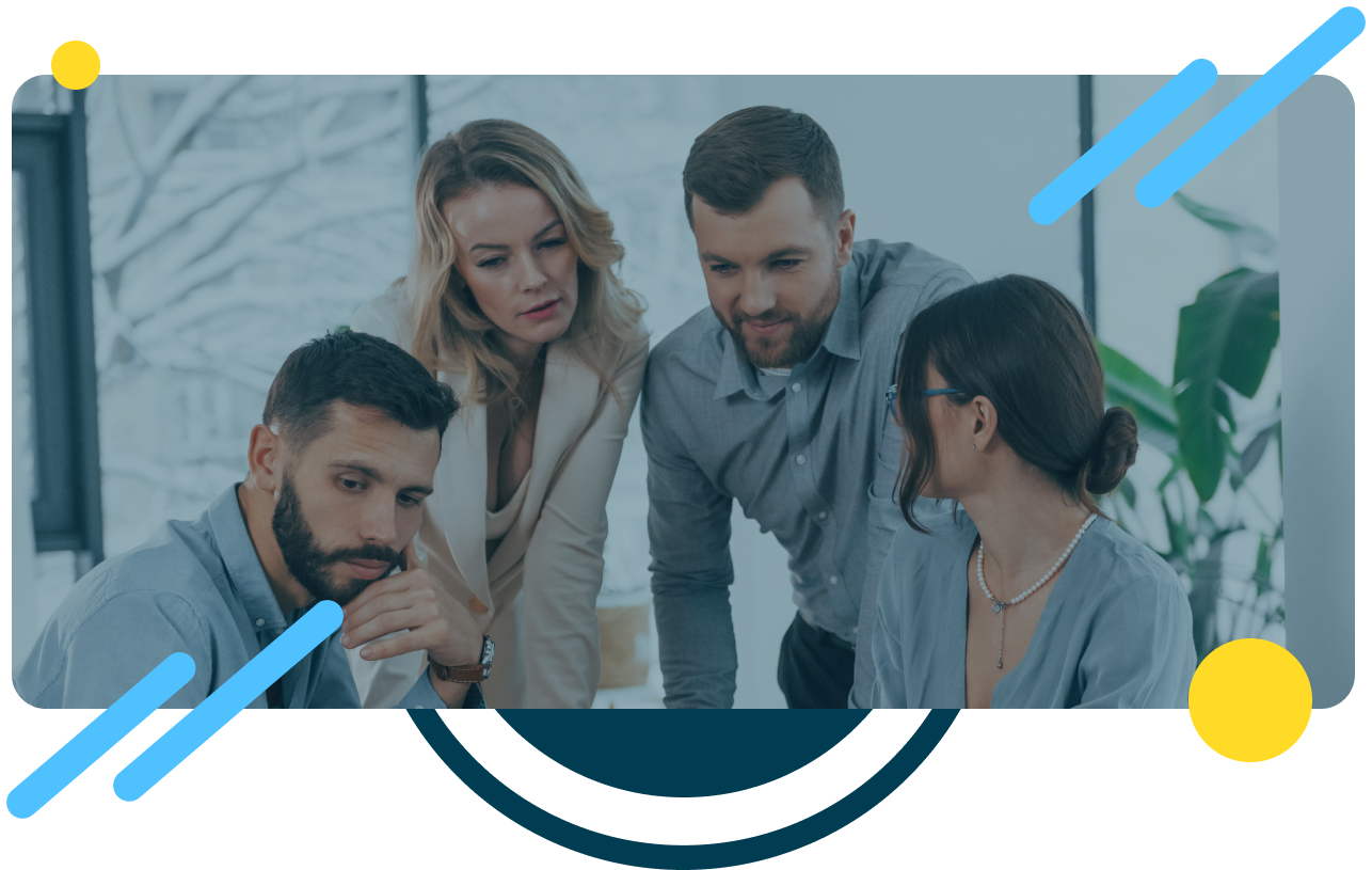 Picture of a group of people in font of a computer